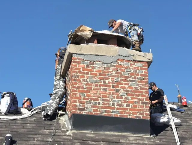 Weston Chimney Sweep installing a custom chimney crown in Weston, MA